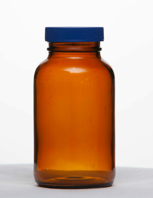 An amber bottle with a teflon-lined blue cap.