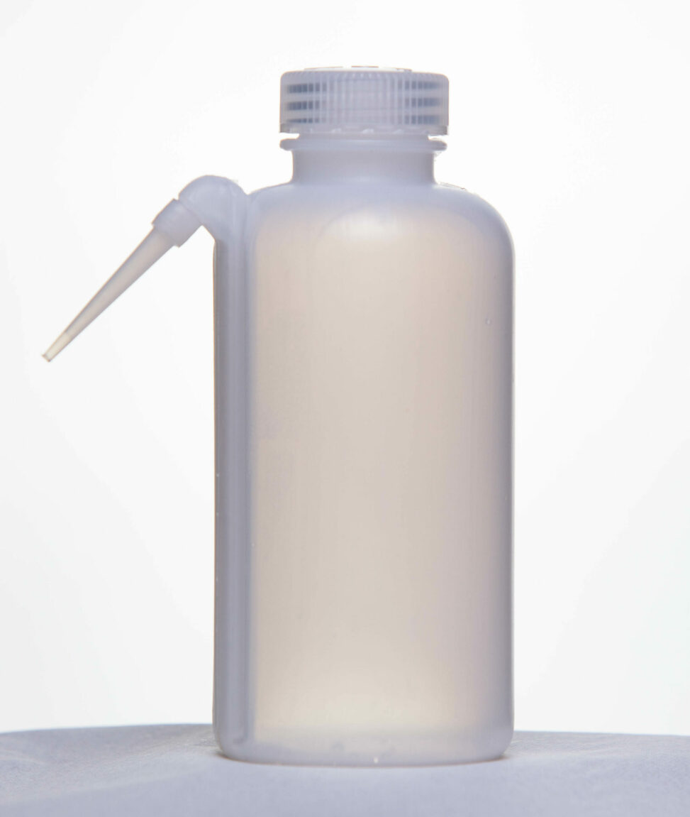 A plastic water squirt bottle with the spout on the side.