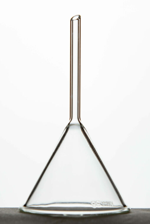 A glass Pyrex long stem funnel sitting upside down.