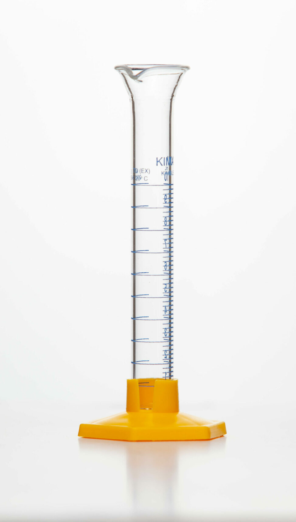 A glass graduated cylinder held upright by a orange stand attached to the bottom.