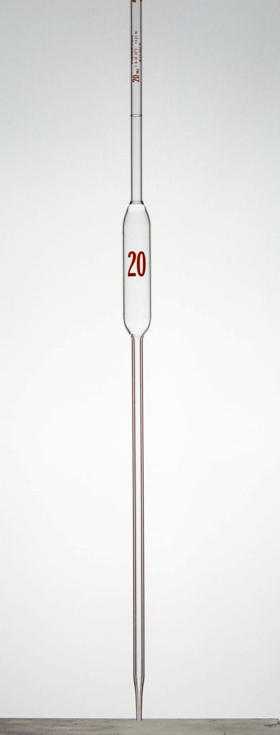 An upright 20 ml volumetric pipette.